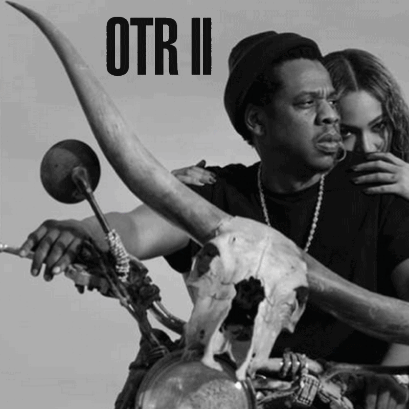 Beyonce and Jay-Z sitting on a motorcycle with their OTR II tour logo in the background