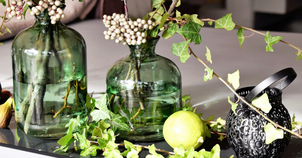 Two green decorative vases and a silver vase 