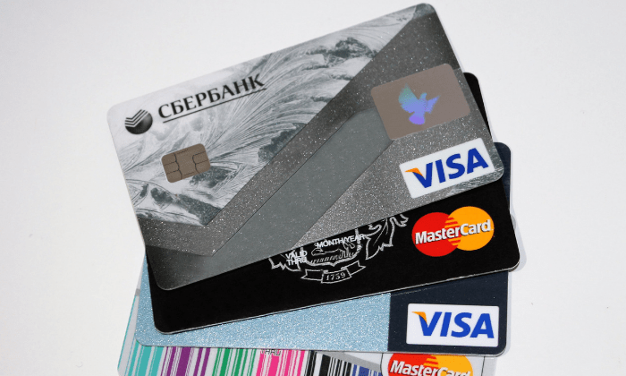 picture of 4 different credit cards. Eliminate debt to save more money