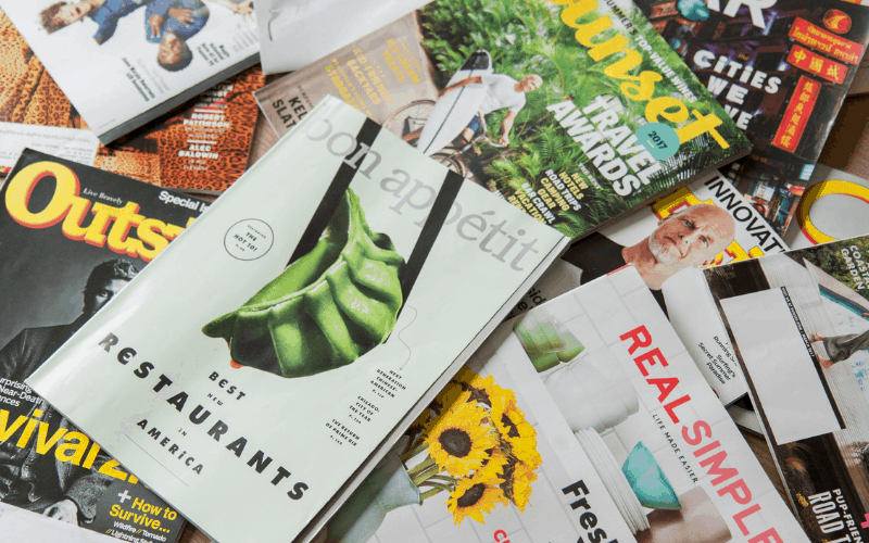A pile of magazines spread out. stop subscriptions to help kick start your finances