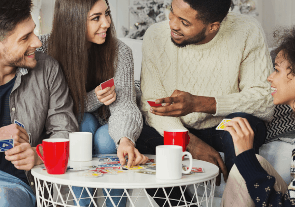 Two couples playing cards