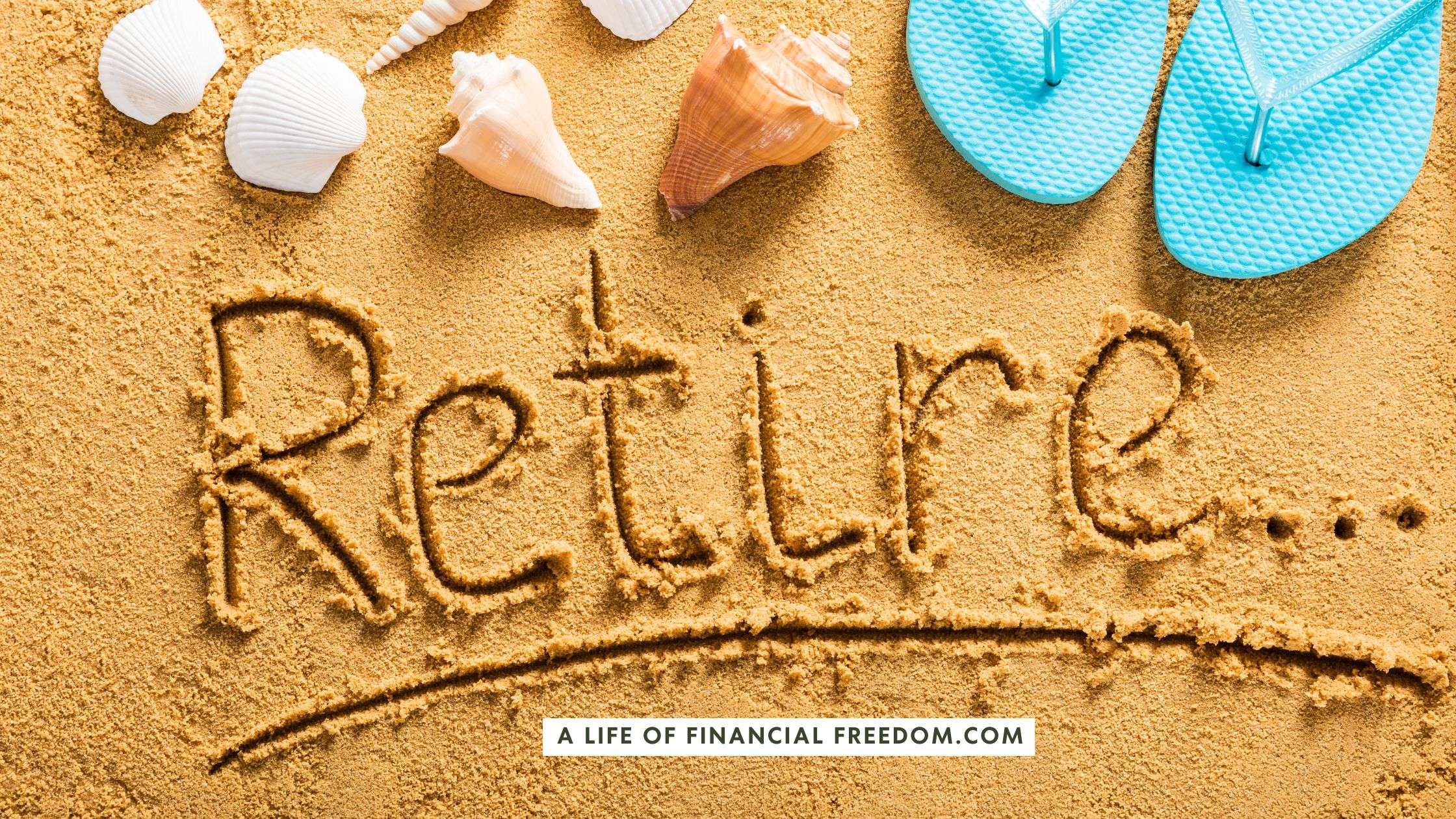 Beach sand with sea shells and with the word 'Retire' written in the sand